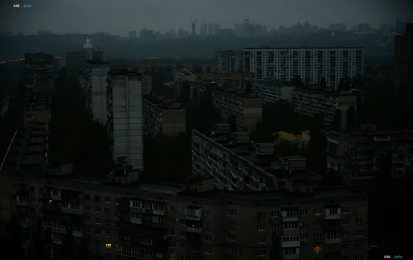Panoramic view of a Kyiv residential district at dusk with apartment windows plunged into darkness due to power outages