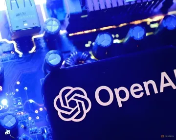 OpenAI logo against the background of a blue-lit computer circuit board